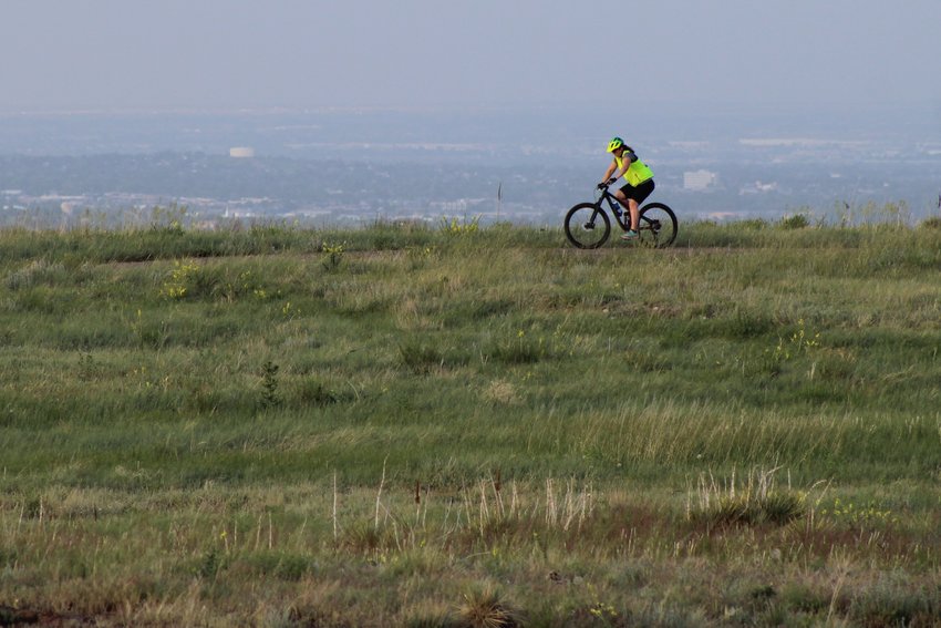 A cyclist bikes along South Table Mountain's Old Quarry Trail on June 16.